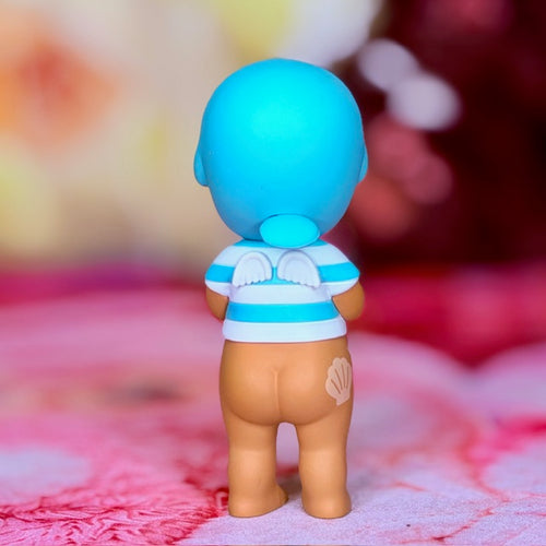 Manatee-style toy figure with bright blue head, white-and-blue swim top, tan body