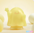 Yellow character-shaped scented candle with wick and smiling face