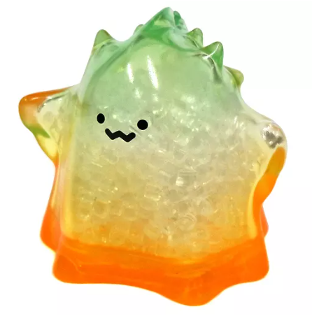 Transparent green and orange jelly figure with smiling face, glossy texture.